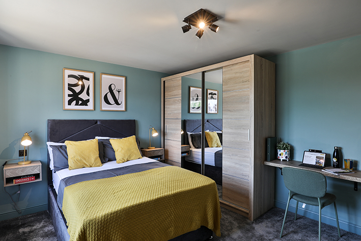 Comfortable private bedroom with dedicated study desk and ample storage in B-Hive Living home near Bicester Motion