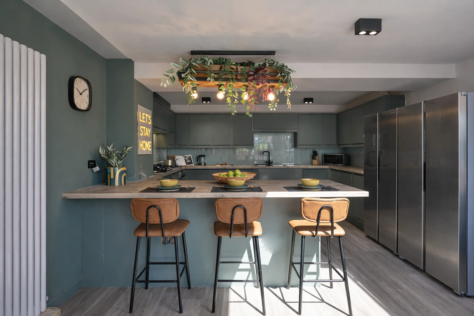 High-spec modern kitchen and breakfast island at B-Hive Living, ideal for cooking and unwinding around Bicester Village shifts