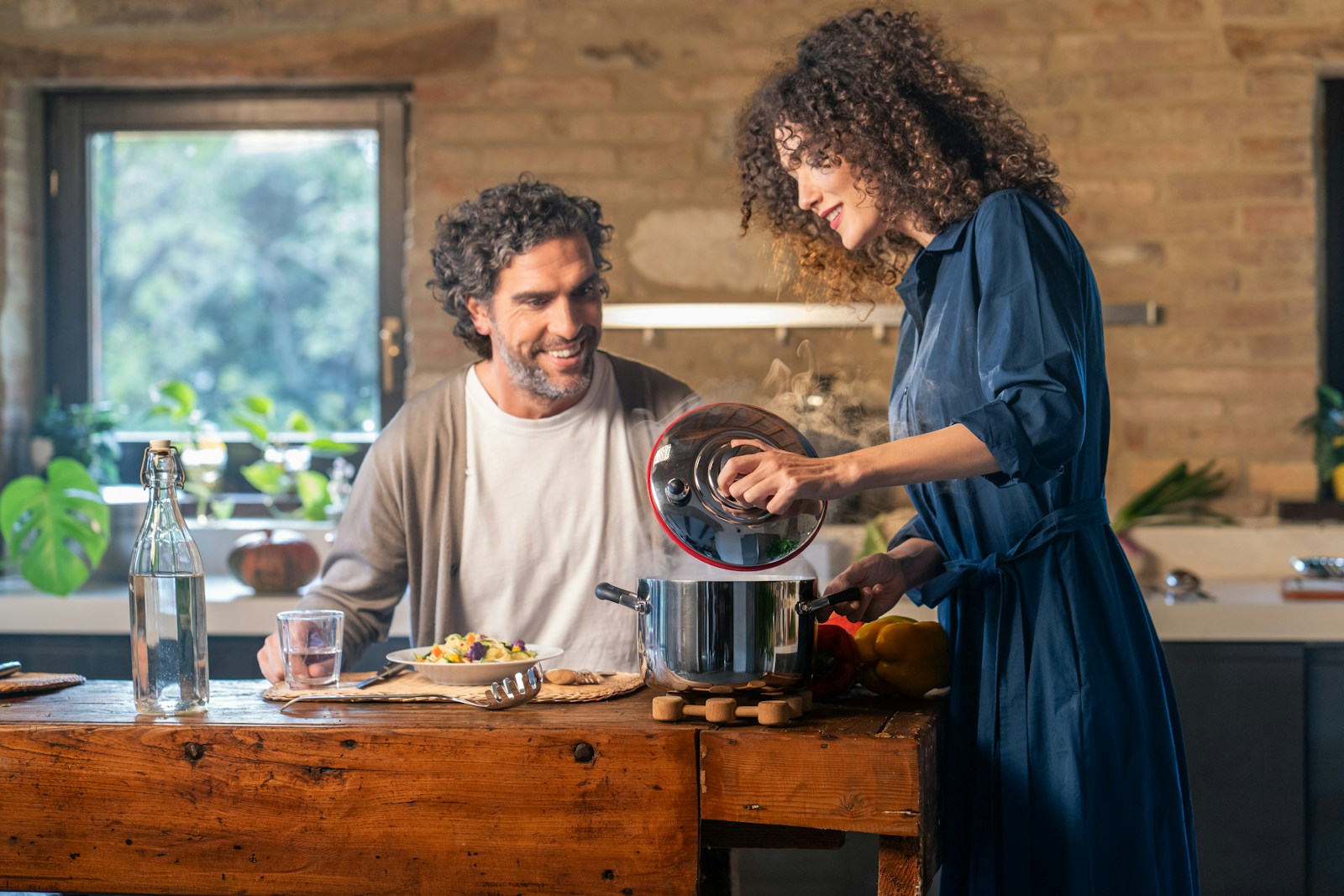 Residents cooking a warm dinner together in a home kitchen after a demanding work shift