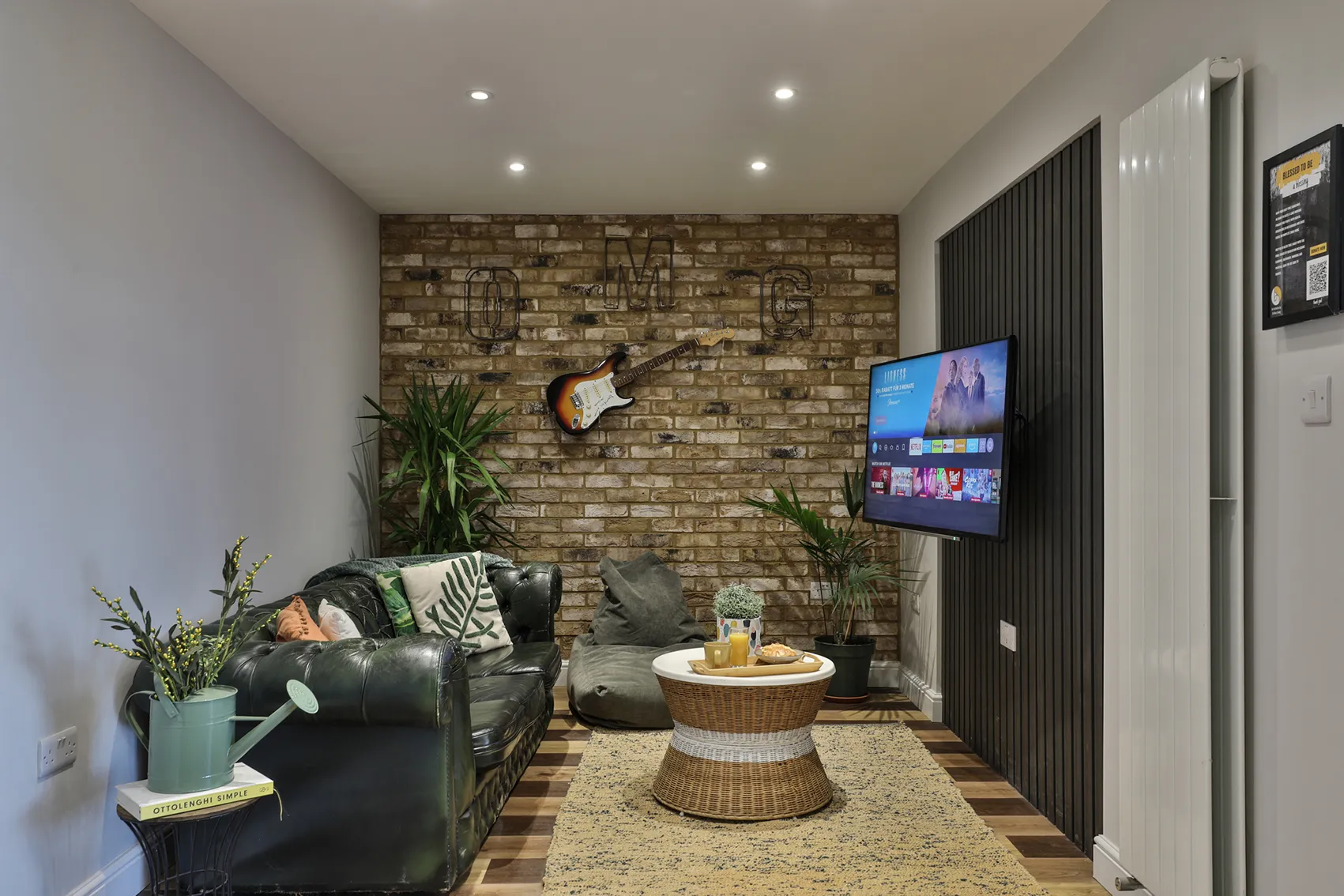 Cozy communal lounge with brick feature wall and comfortable seating in central Bicester