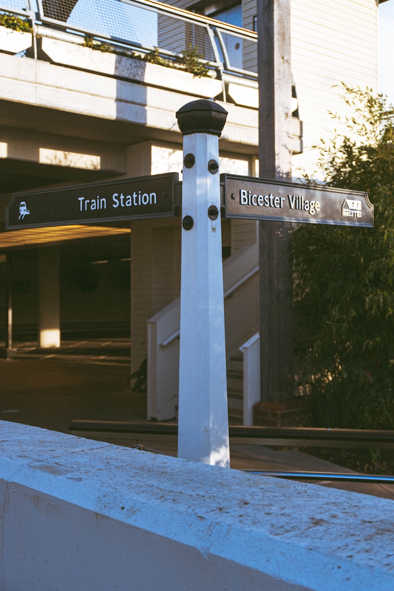 Train station directional signpost at Bicester Village station